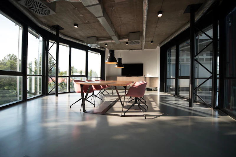 A meeting table and chairs set out in a newly completed glazed office